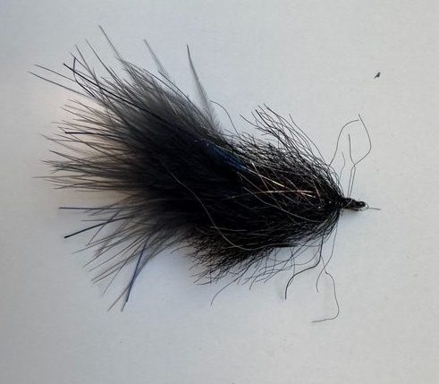 The best fly for snook and tarpon in Grand Cayman, Cayman Islands, a black streamer fly with synthetic flash and marabou